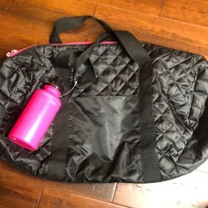 Black and pink bag with pink water bottle